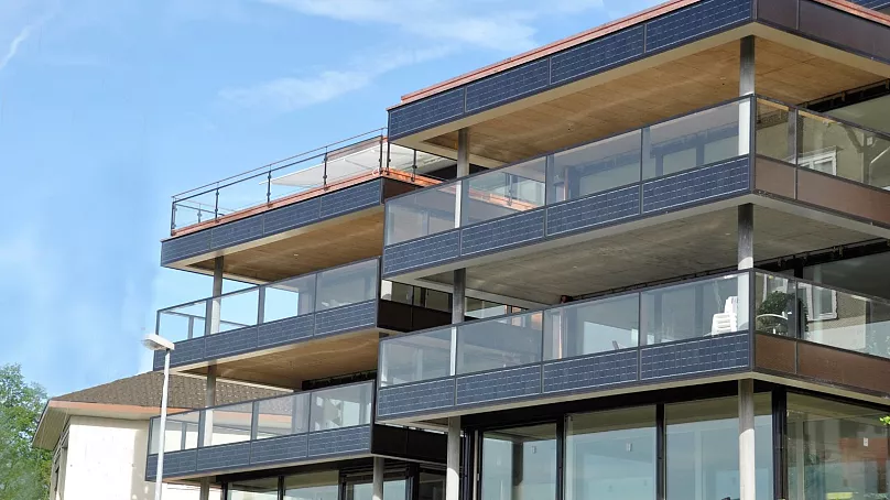 Balcony solar integrated into a multifamily building facade