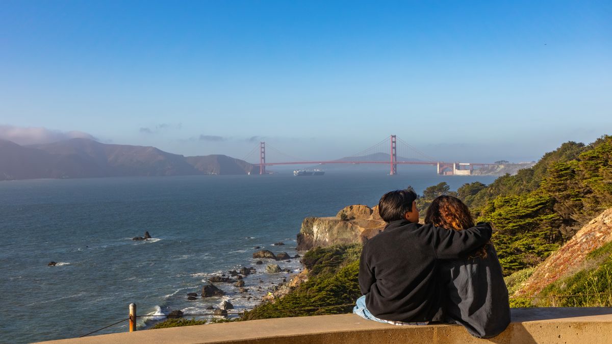 Couple overlooking the Golden Gate Bridge from the San Francisco coast